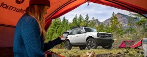 A view of a silver 2021 Ford Bronco through the opening of a camping tent near San Antonio, TX