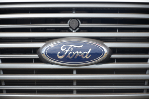 A close-up of the Ford logo on the grille of a Ford F-250 near San Antonio, TX