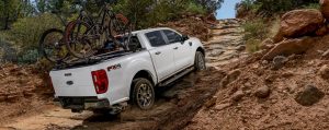 Driving a Ford Ranger truck in a dried river bed during the summer